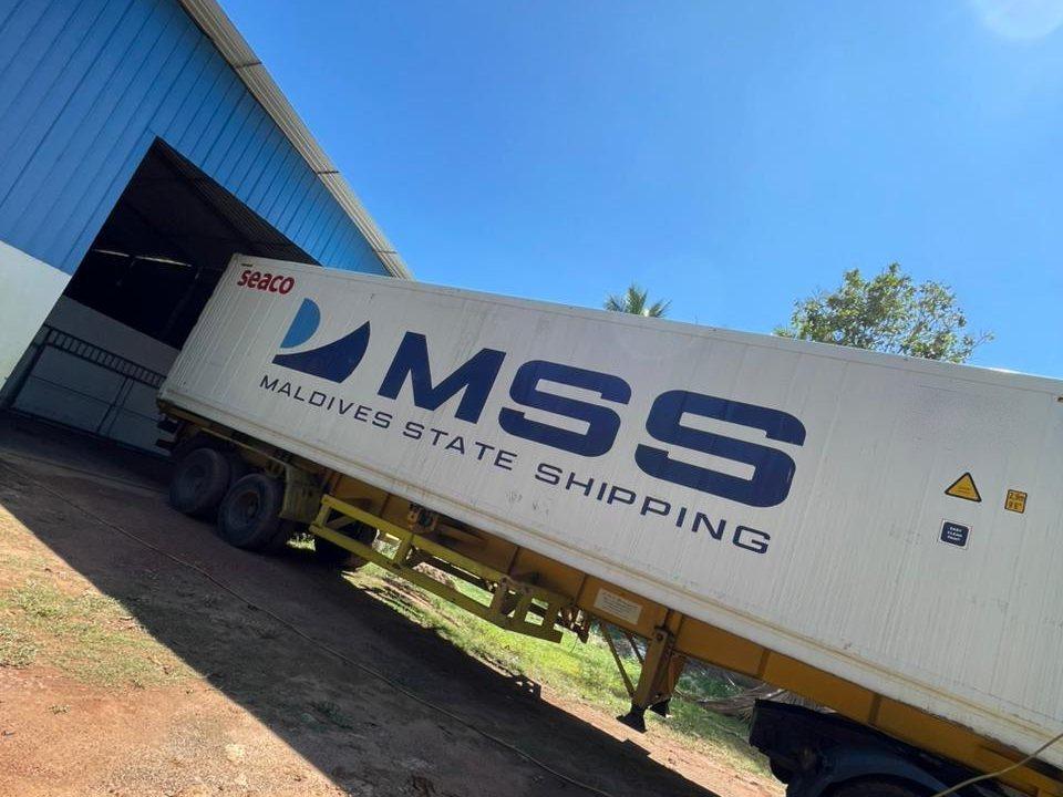 A loaded shipping container on its trailer outside the packing shed
